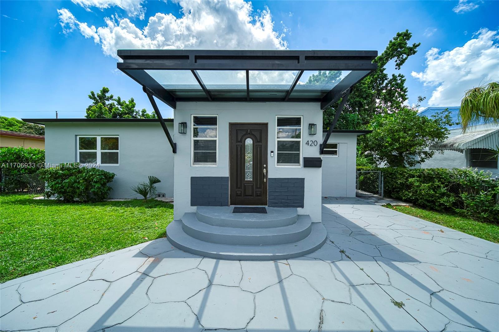 a porch with a table and chairs in patio