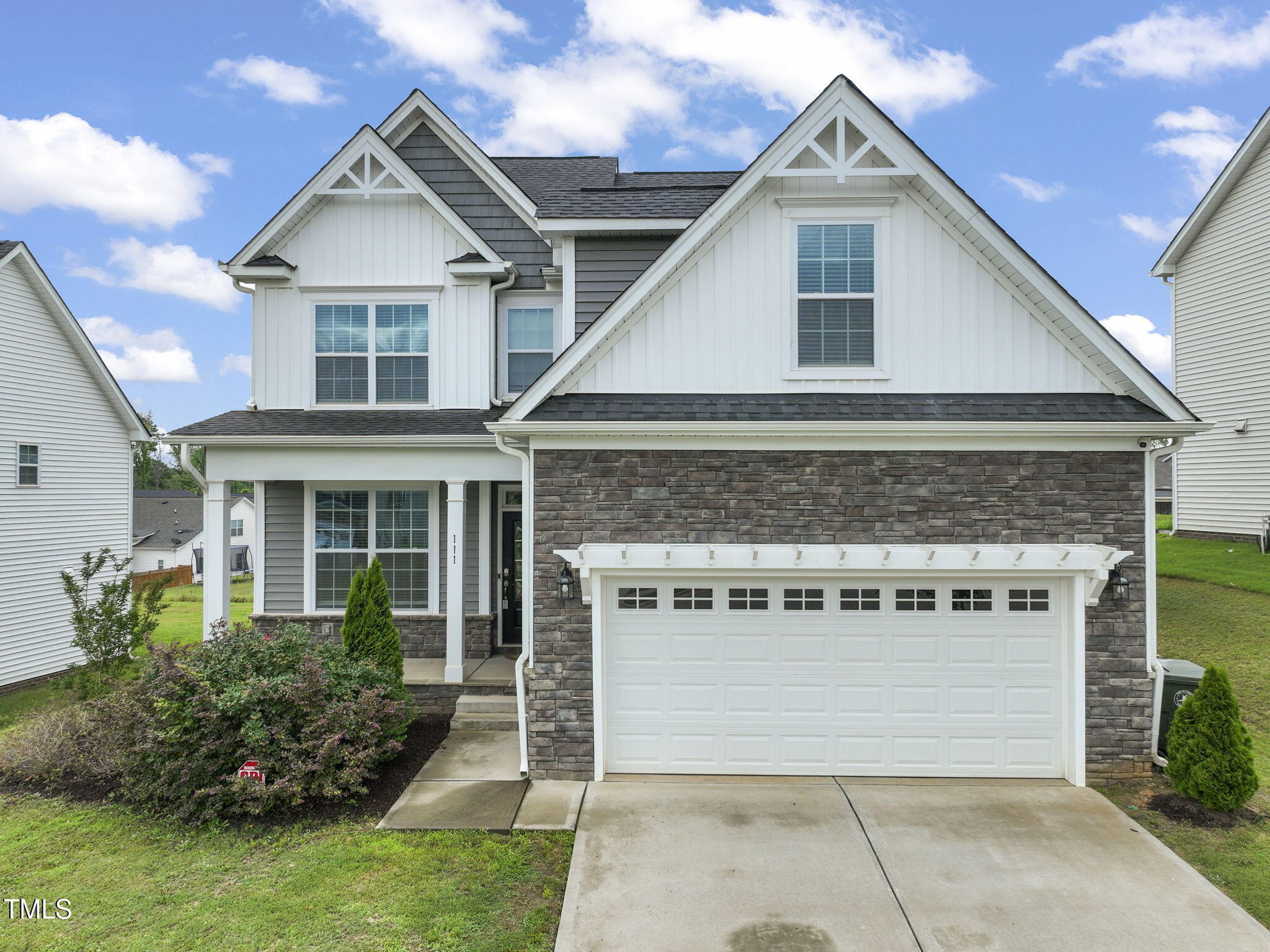 a front view of a house with a garage