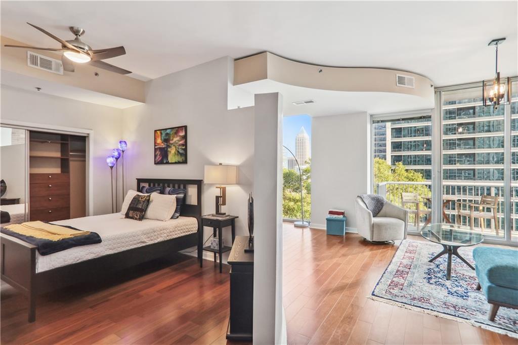 a bedroom with a bed and wooden floor