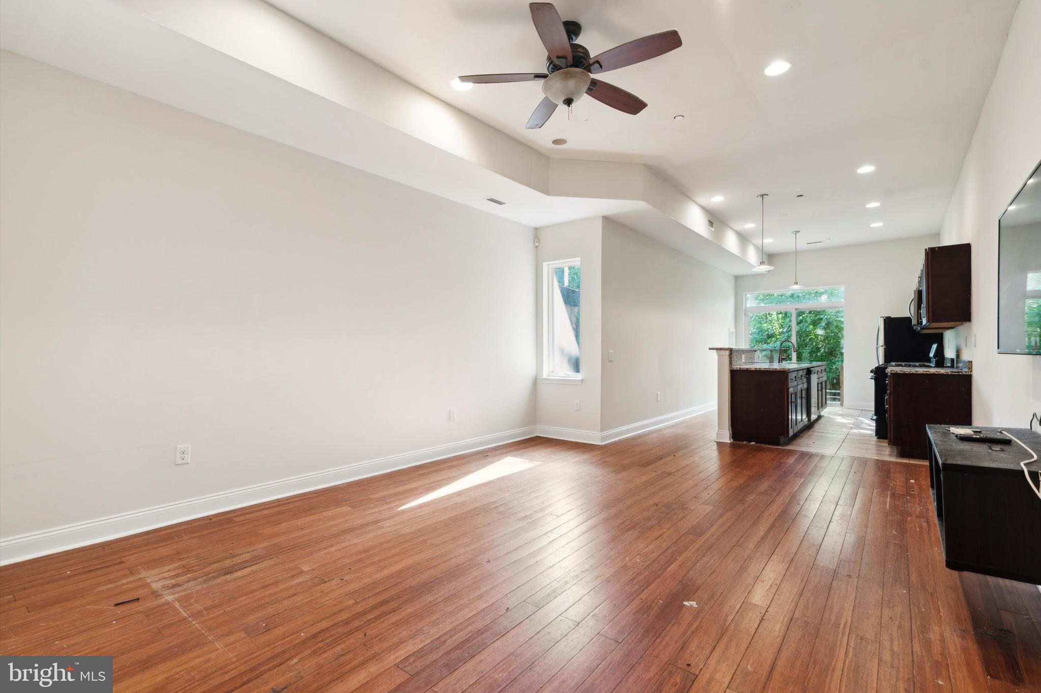 a view of a living room hardwood floor and a window