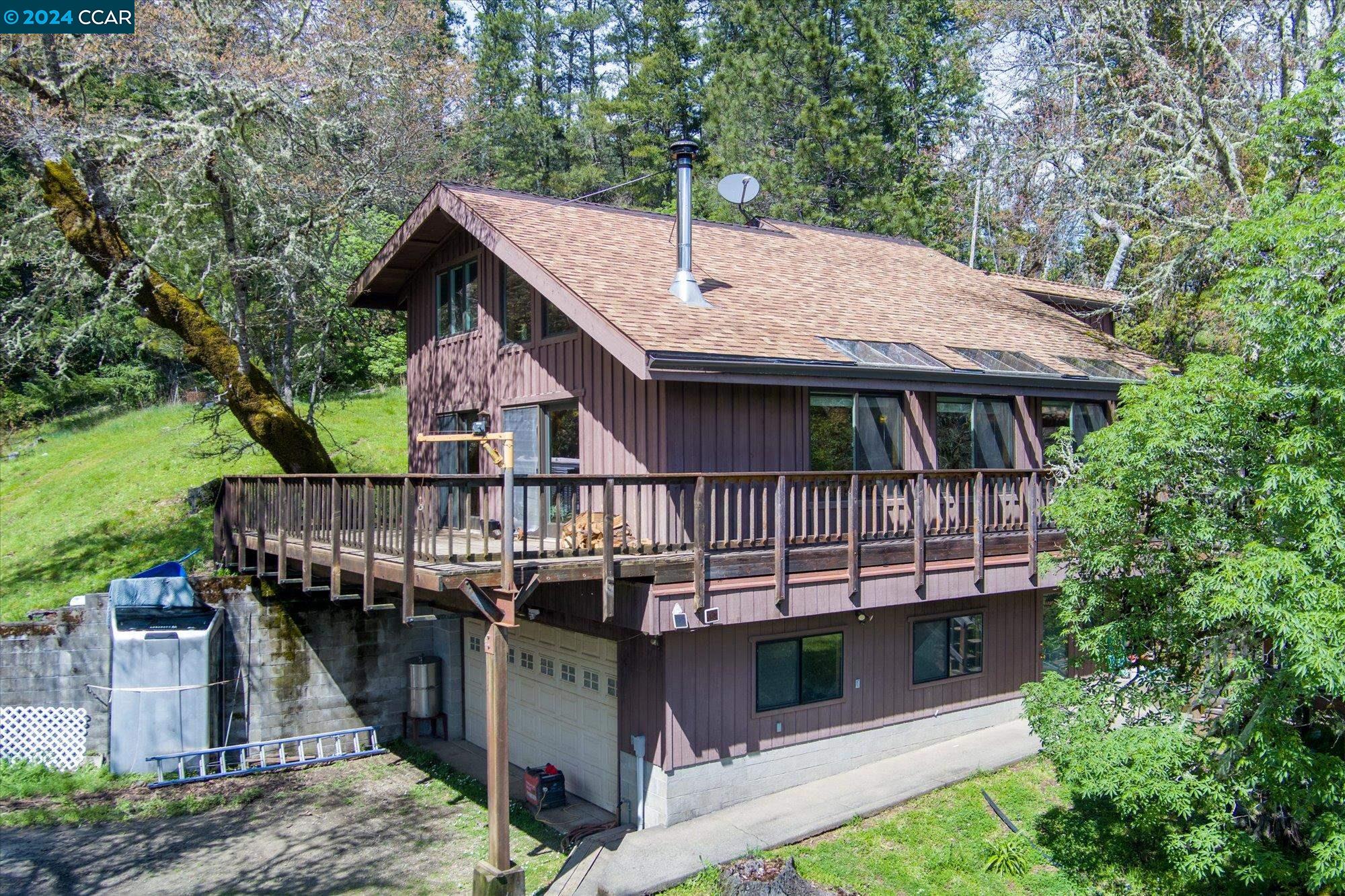 a view of a house with a deck and furniture