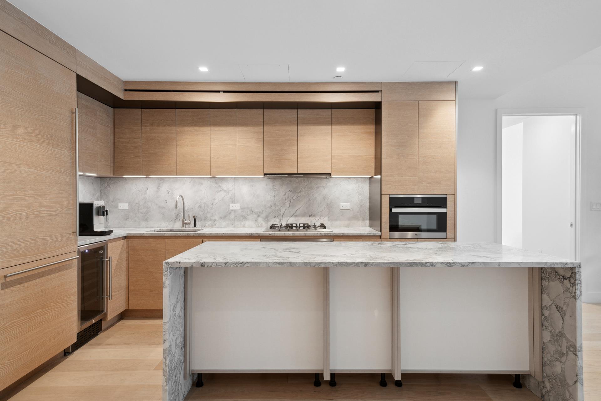 a kitchen with stainless steel appliances granite countertop a stove and a refrigerator