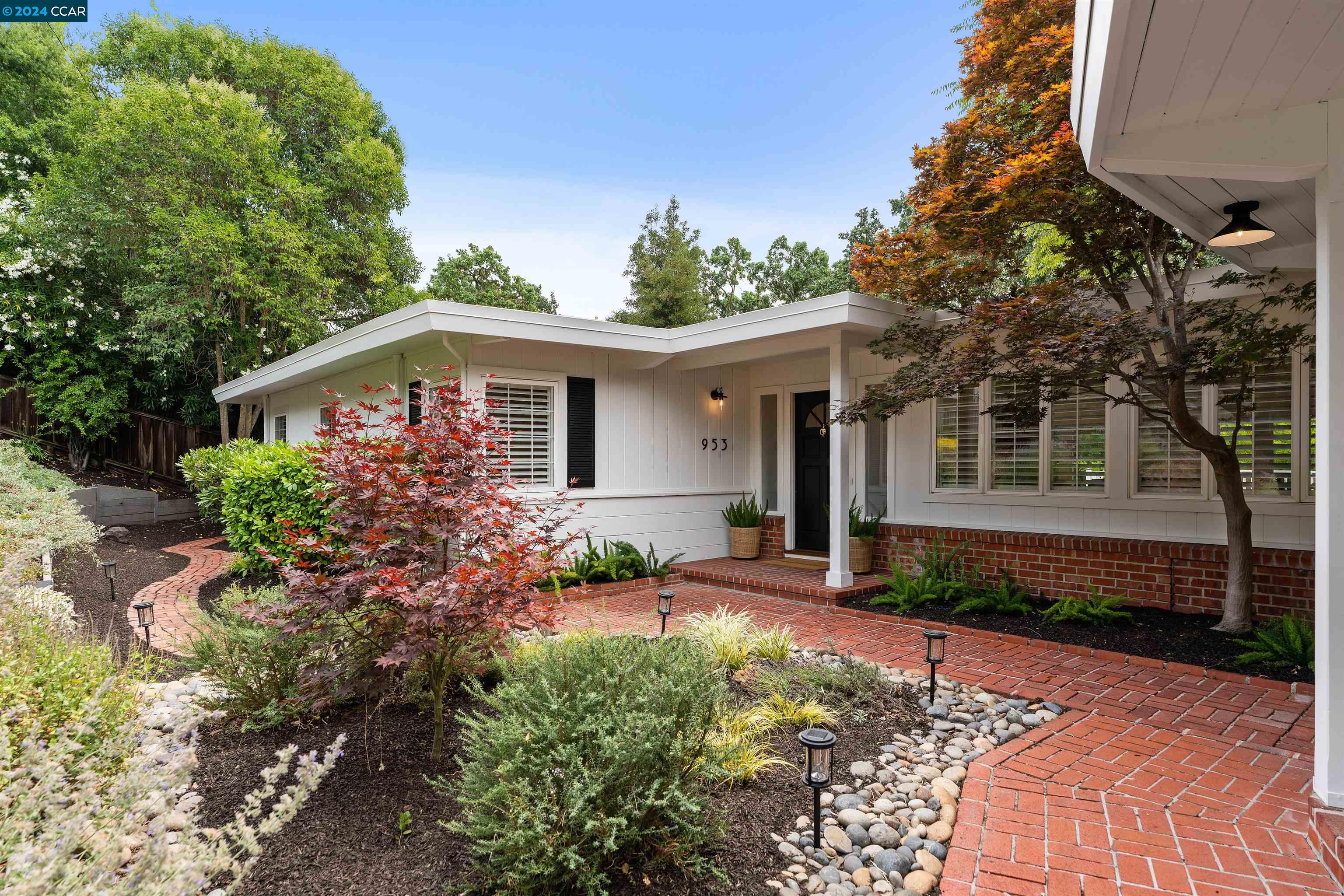 a front view of a house with garden