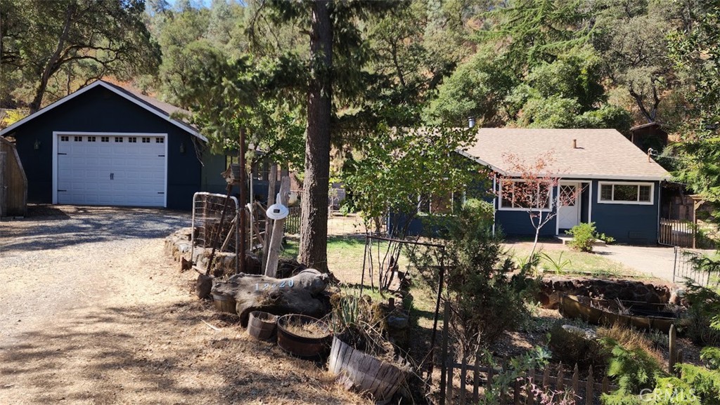 a front view of a house with a yard garage and outdoor seating