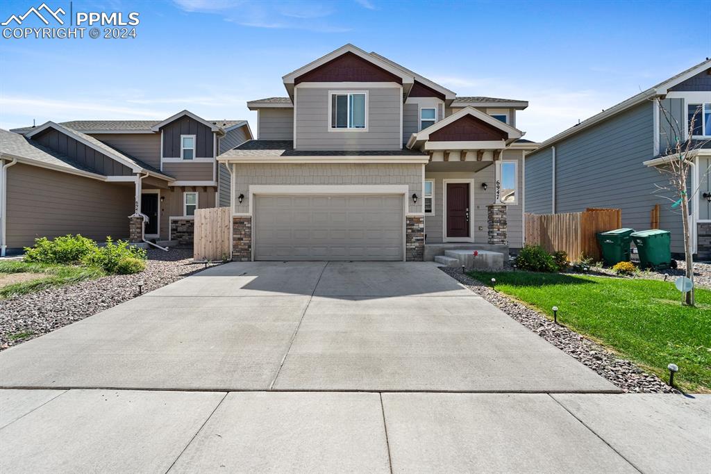 a front view of a house with a yard and garage