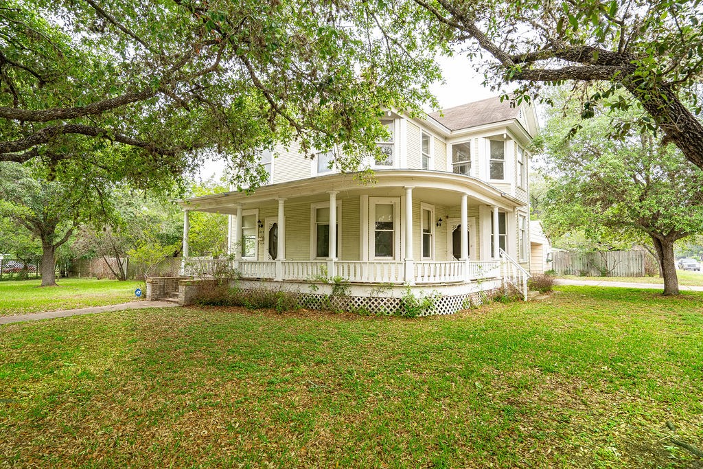 a view of a house with a yard and sitting area