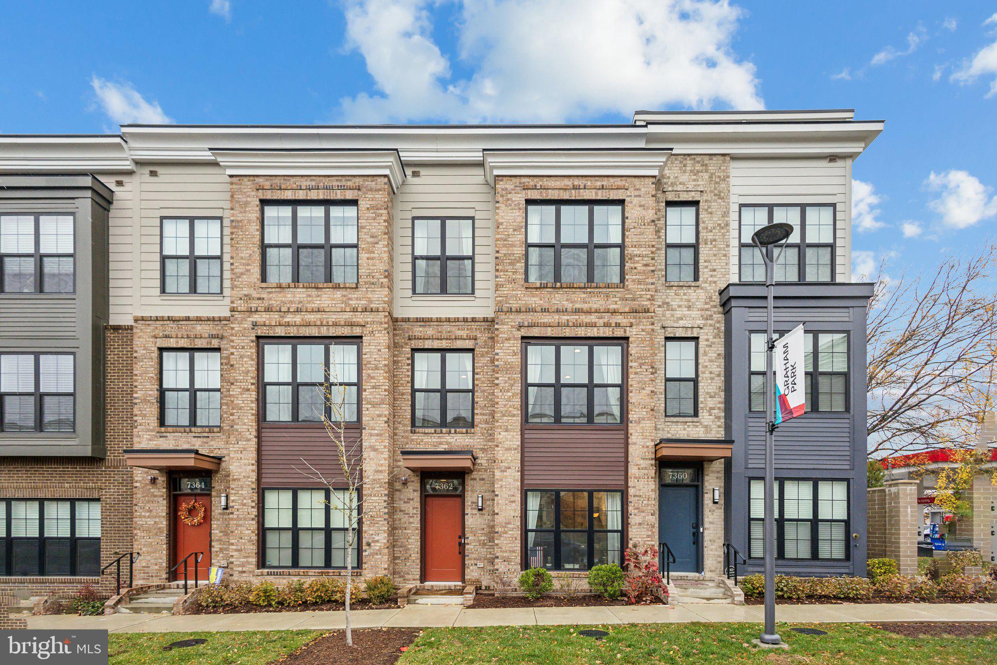 a front view of a residential apartment building with a yard