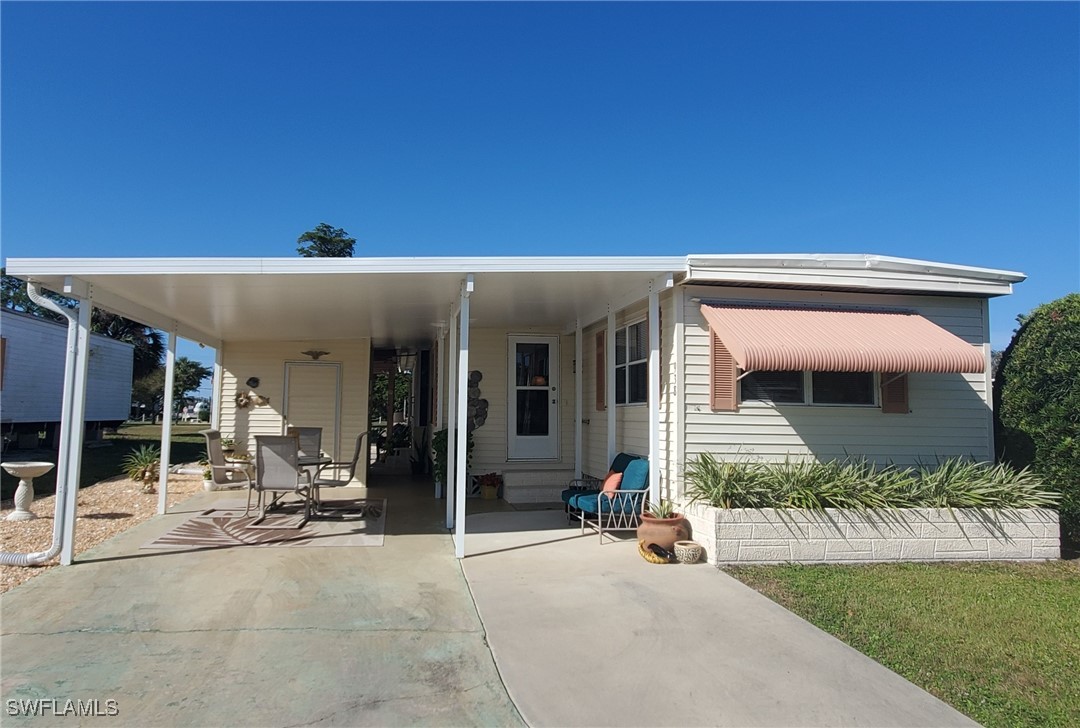 a view of a house with backyard porch and sitting area