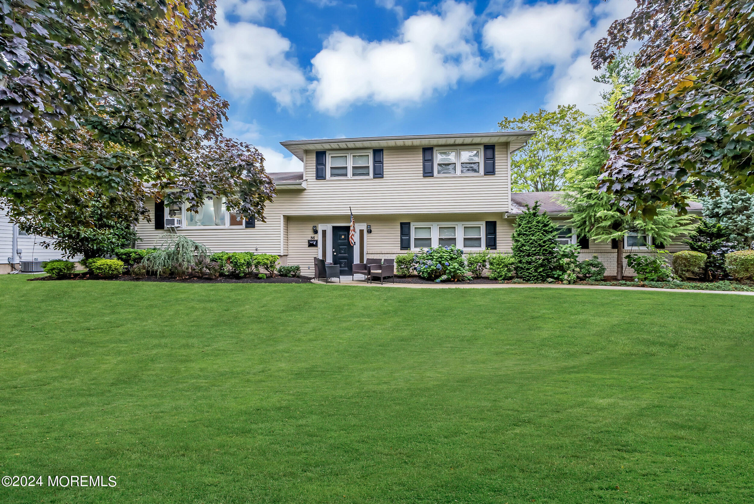 a front view of house with yard and green space