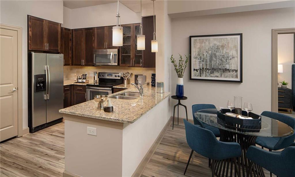 a kitchen with stainless steel appliances granite countertop a sink stove and refrigerator