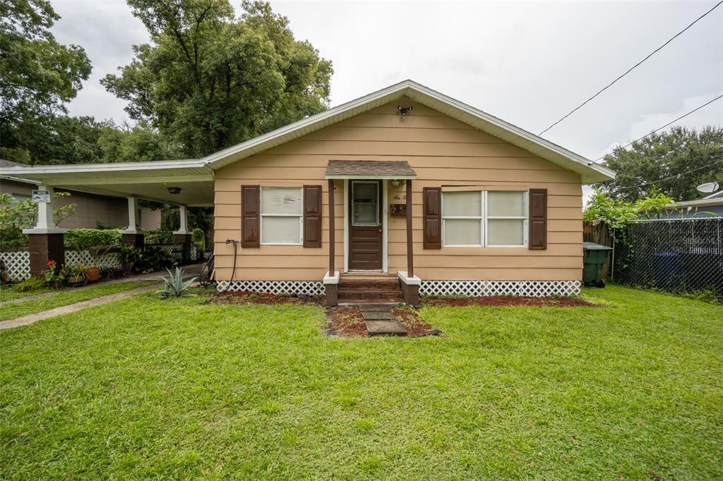 a front view of a house with a garden