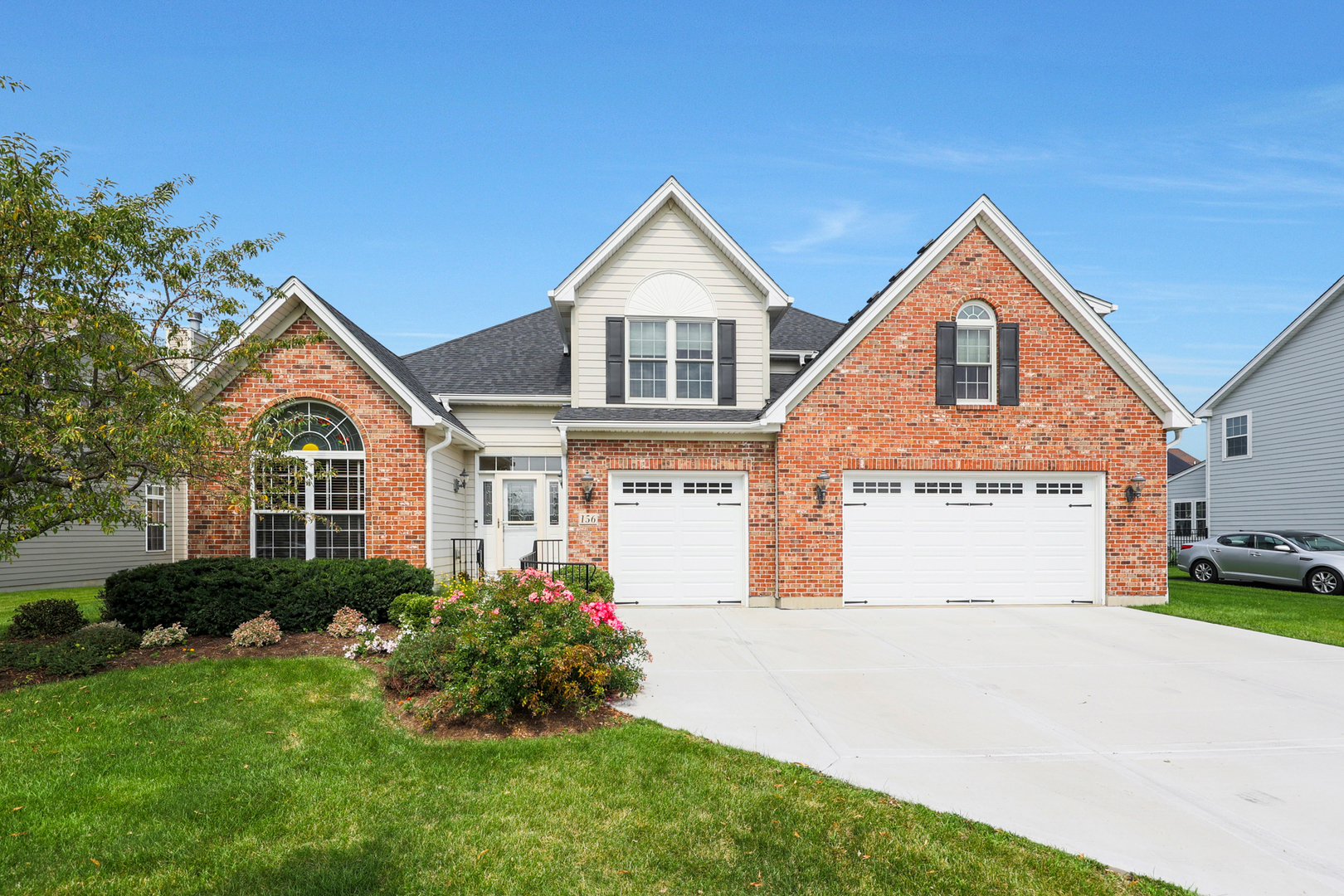 a front view of a house with a yard and garage