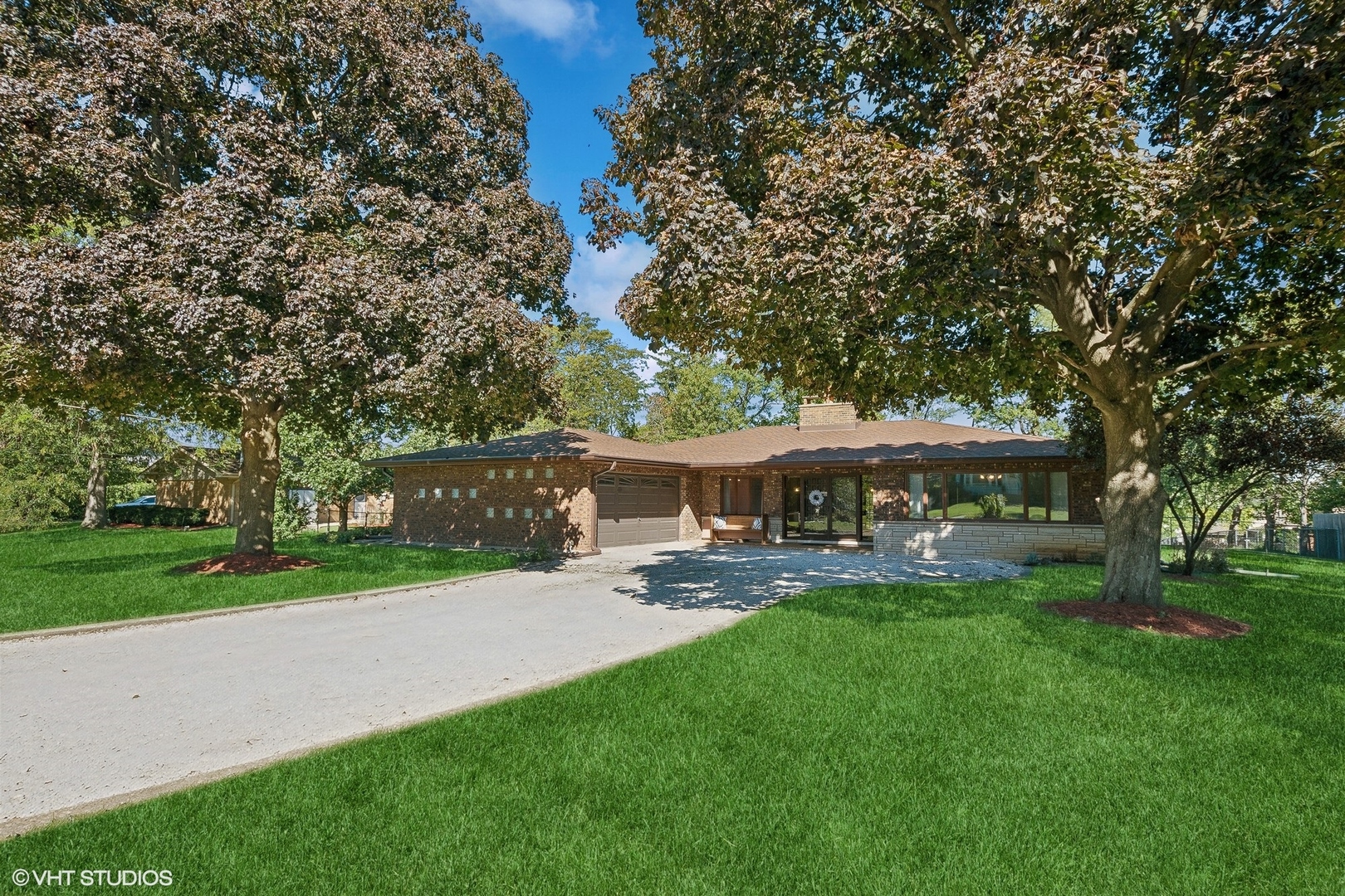 a view of a house with a yard and sitting area