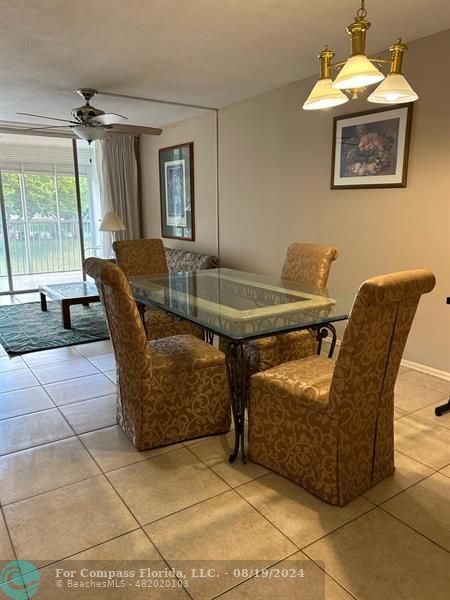 a dining room with furniture and a window