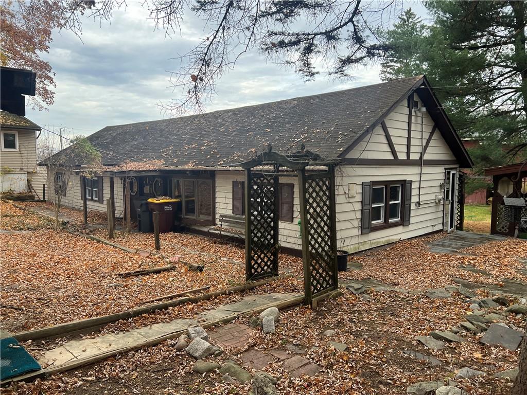 a view of a house with a yard and wooden fence