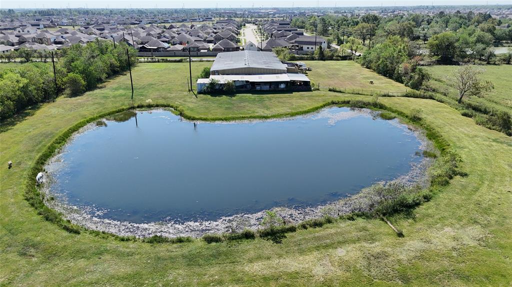 an aerial view of a house with a yard and lake view