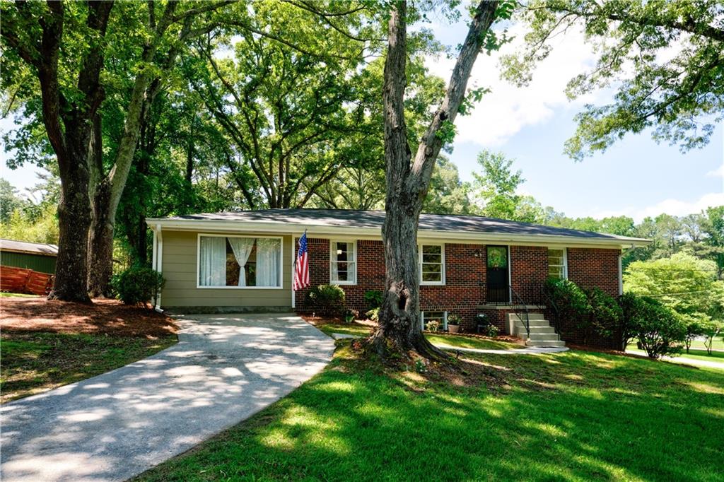 a front view of house with yard and green space