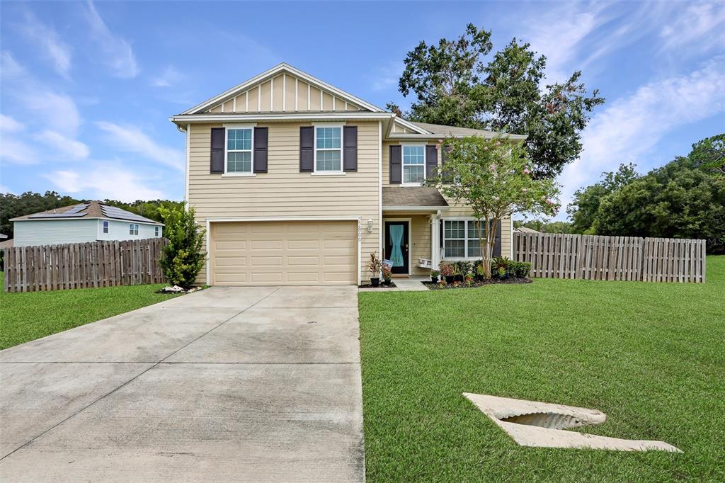 a front view of a house with a yard and garage