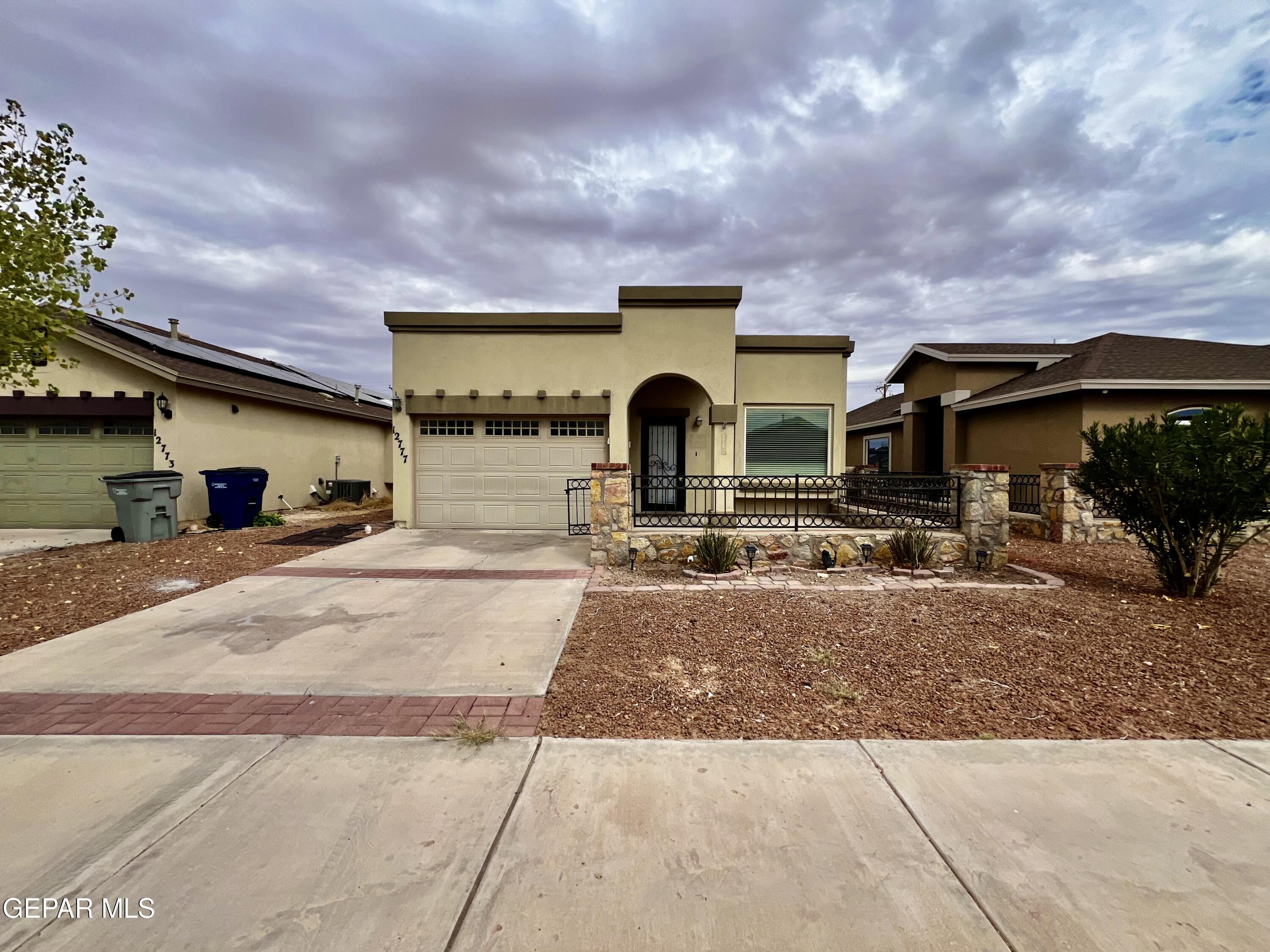 a front view of a house with a yard and a garage