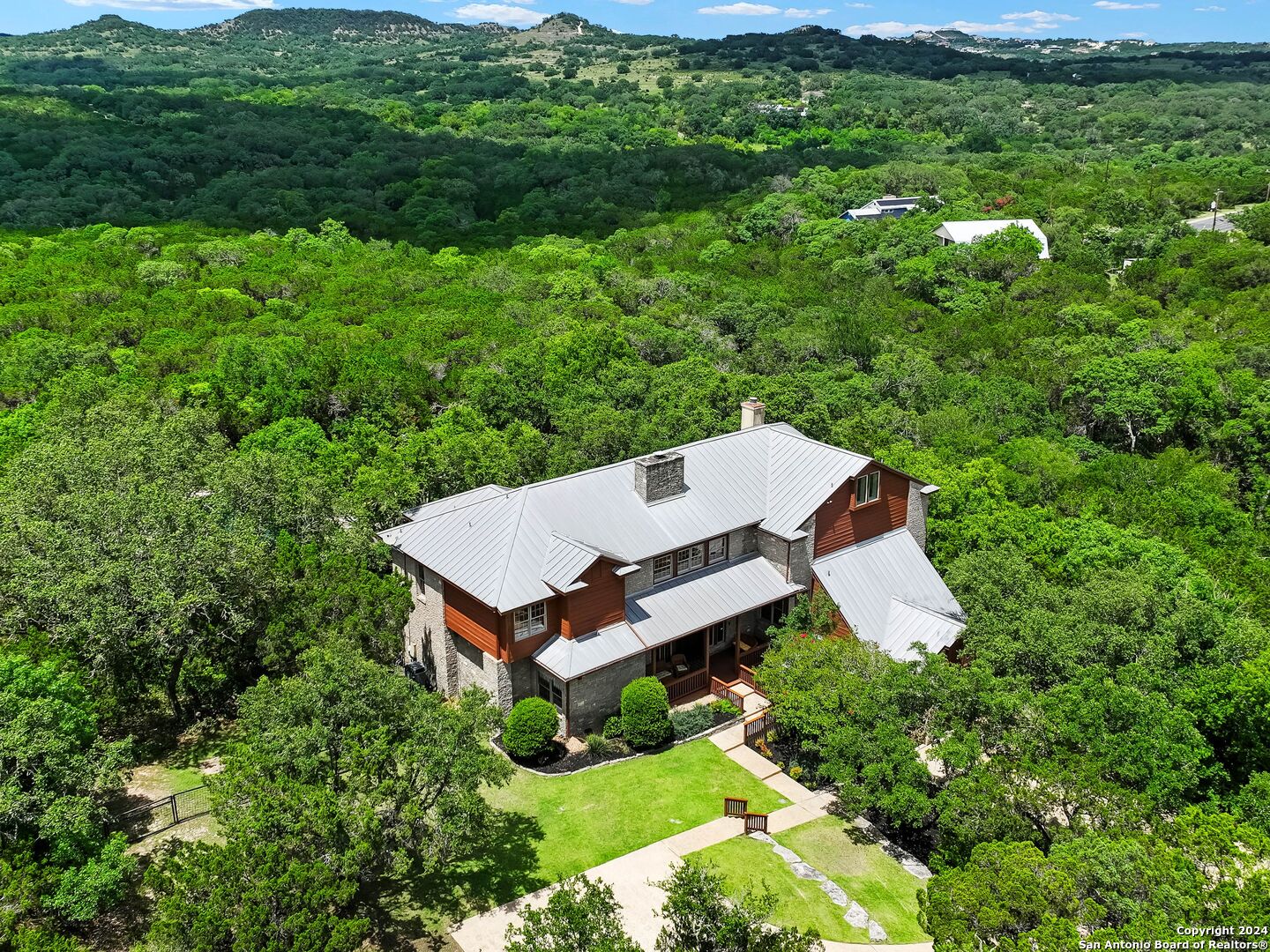 an aerial view of a house with pool yard and mountain view in back