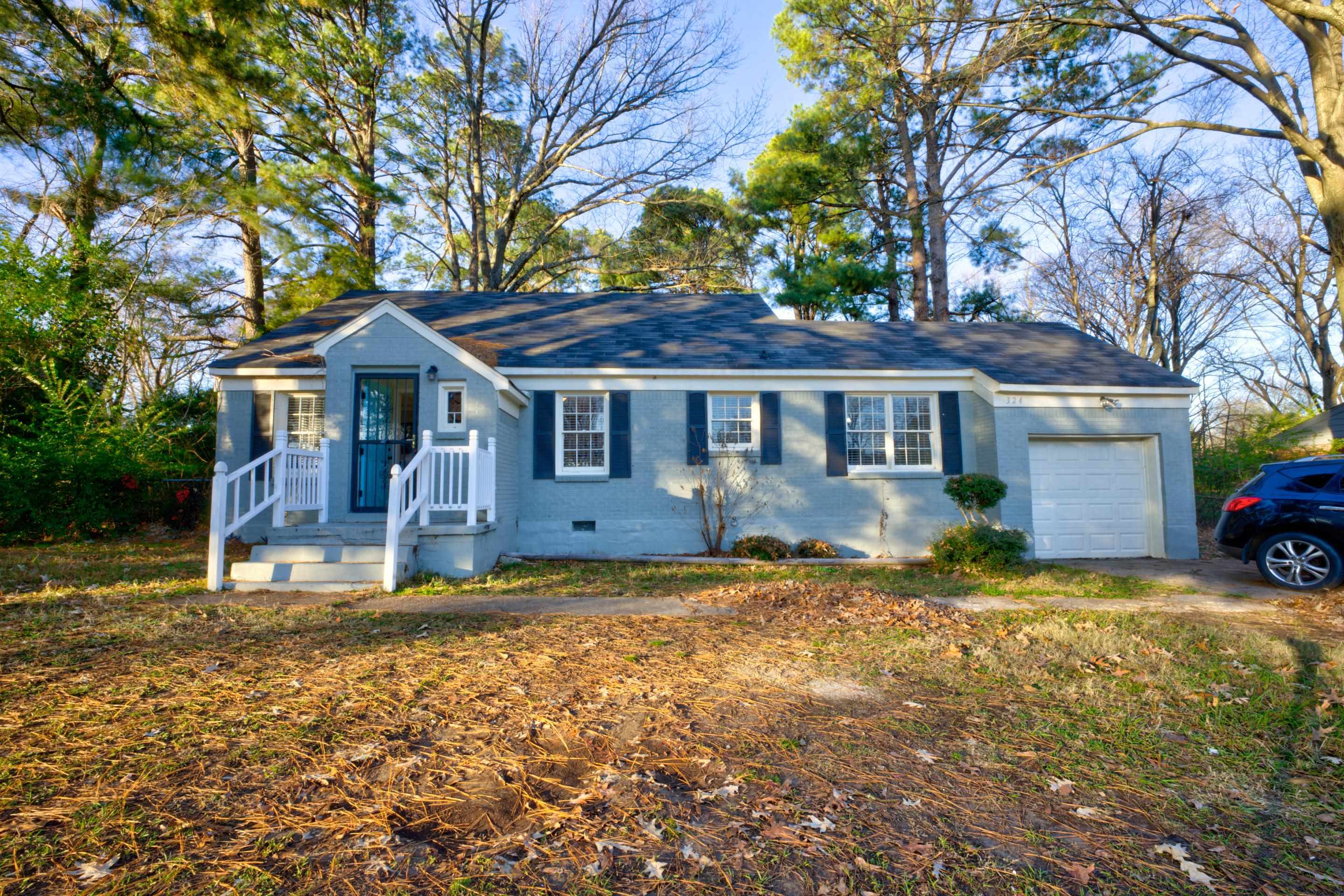 a front view of a house with garden