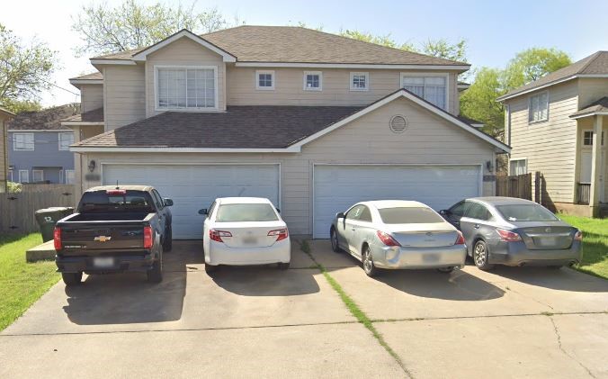 a front view of a house with parking space