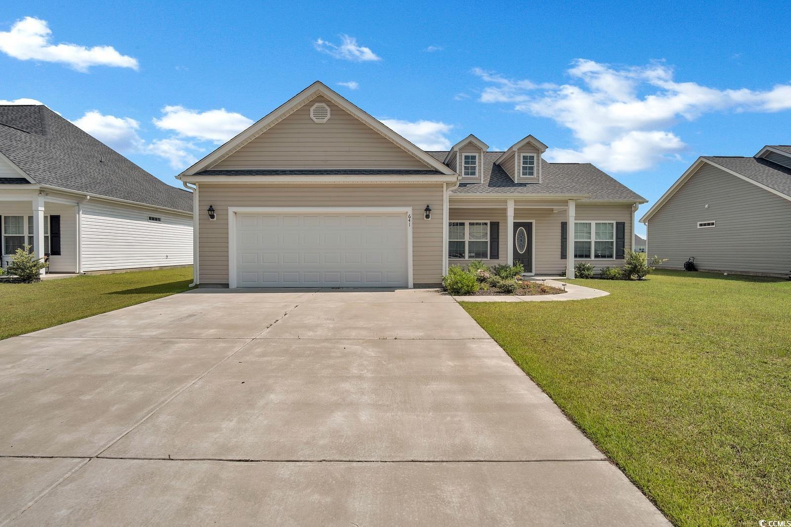 View of front of home featuring a garage and a fro