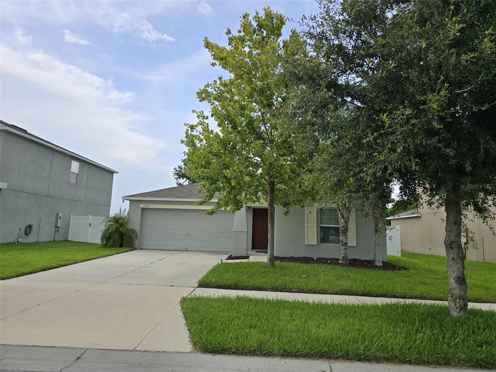 a front view of a house with a garden and yard