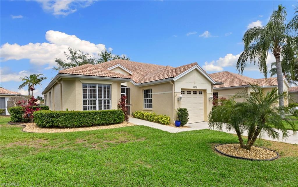 Mediterranean / spanish-style home with a front lawn and a garage