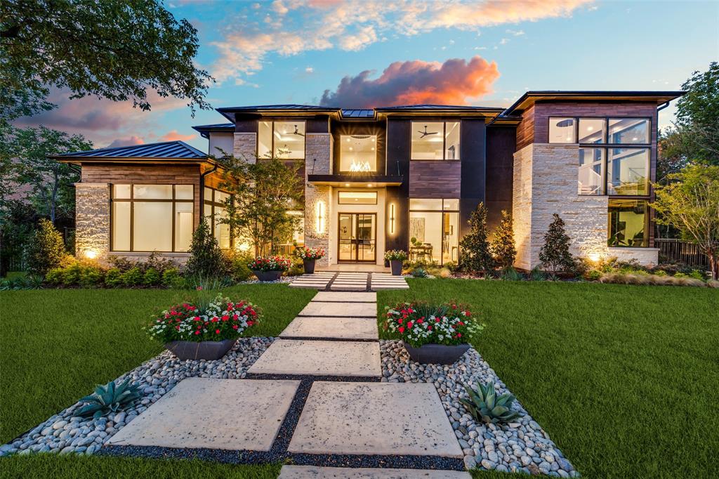 a front view of a house with a yard and outdoor seating