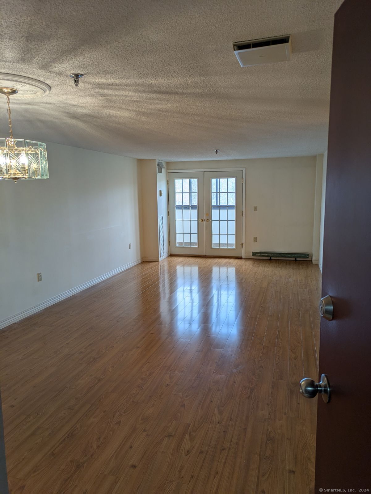 wooden floor in a hall with a window