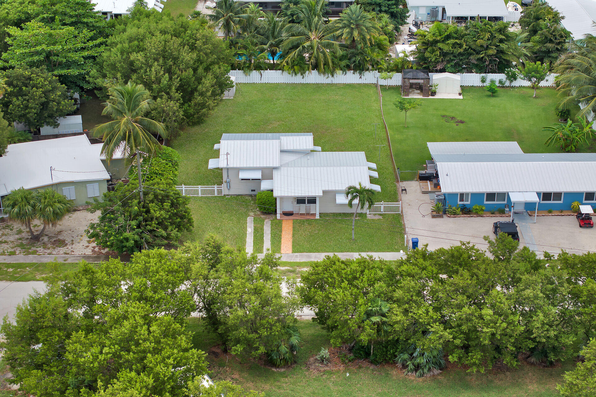 an aerial view of a house with a garden and lake view