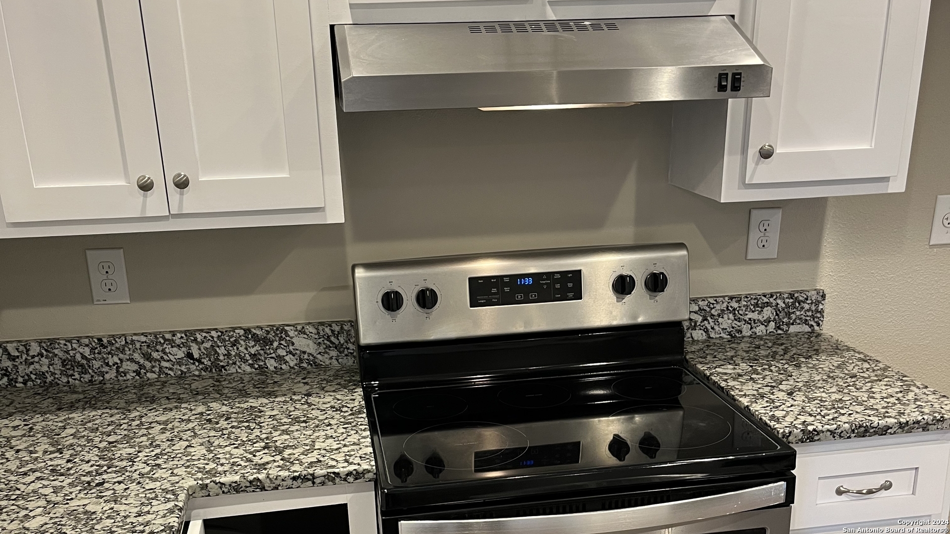 a stove top oven sitting inside of a kitchen