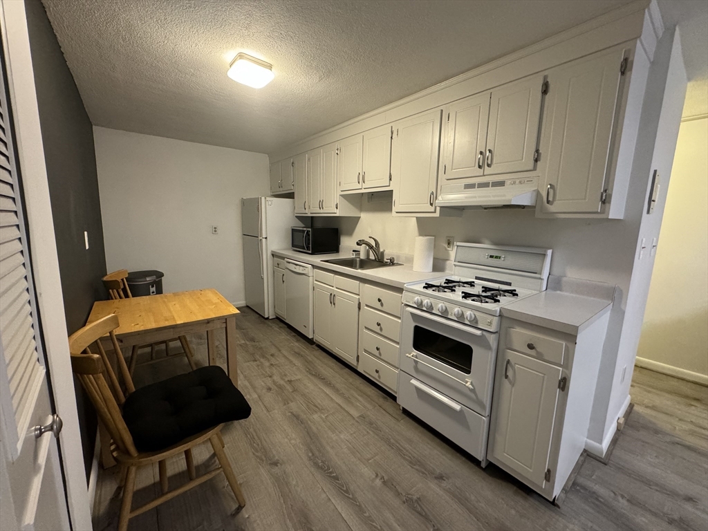 a kitchen with a stove a sink and a refrigerator