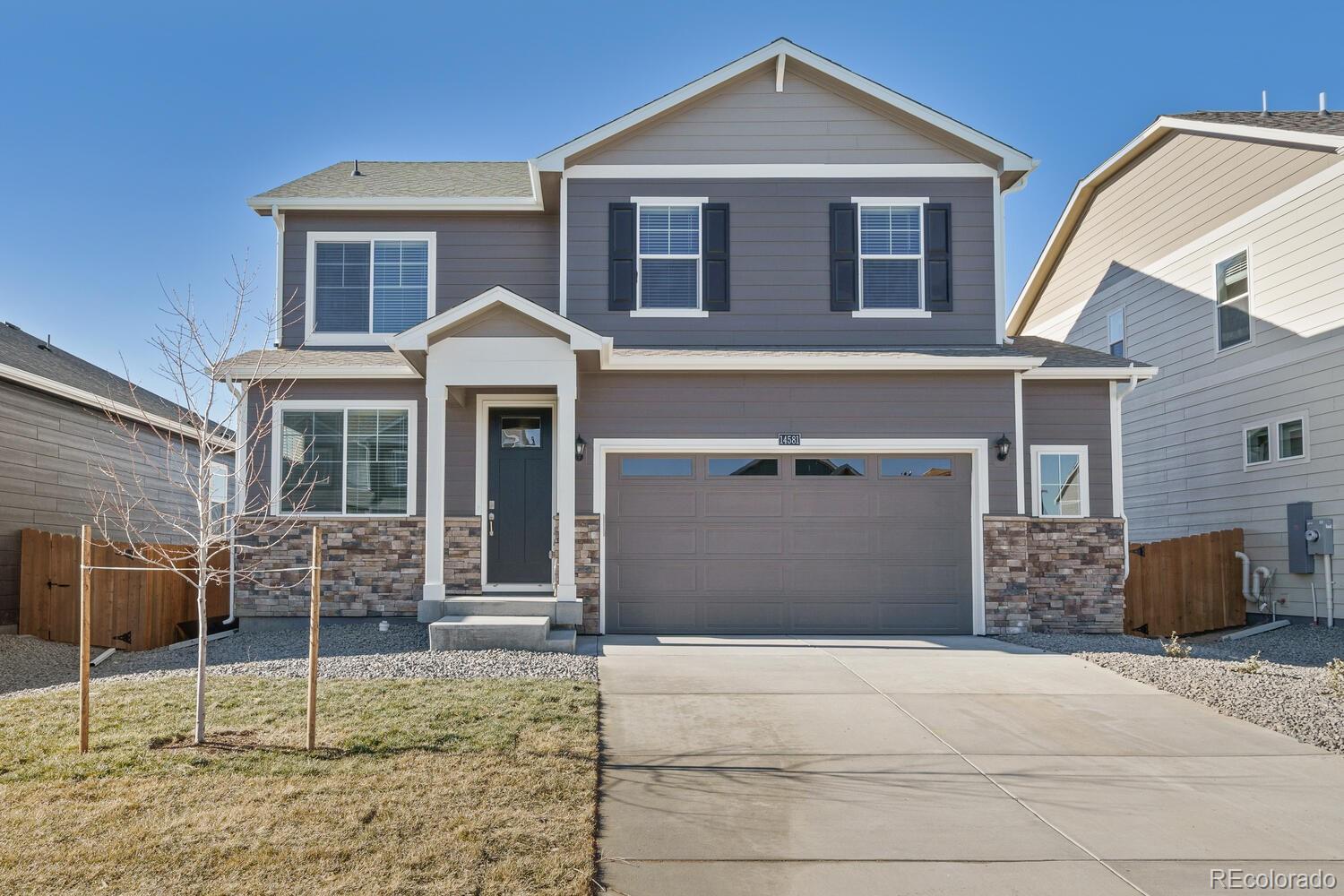 a front view of a house with garage