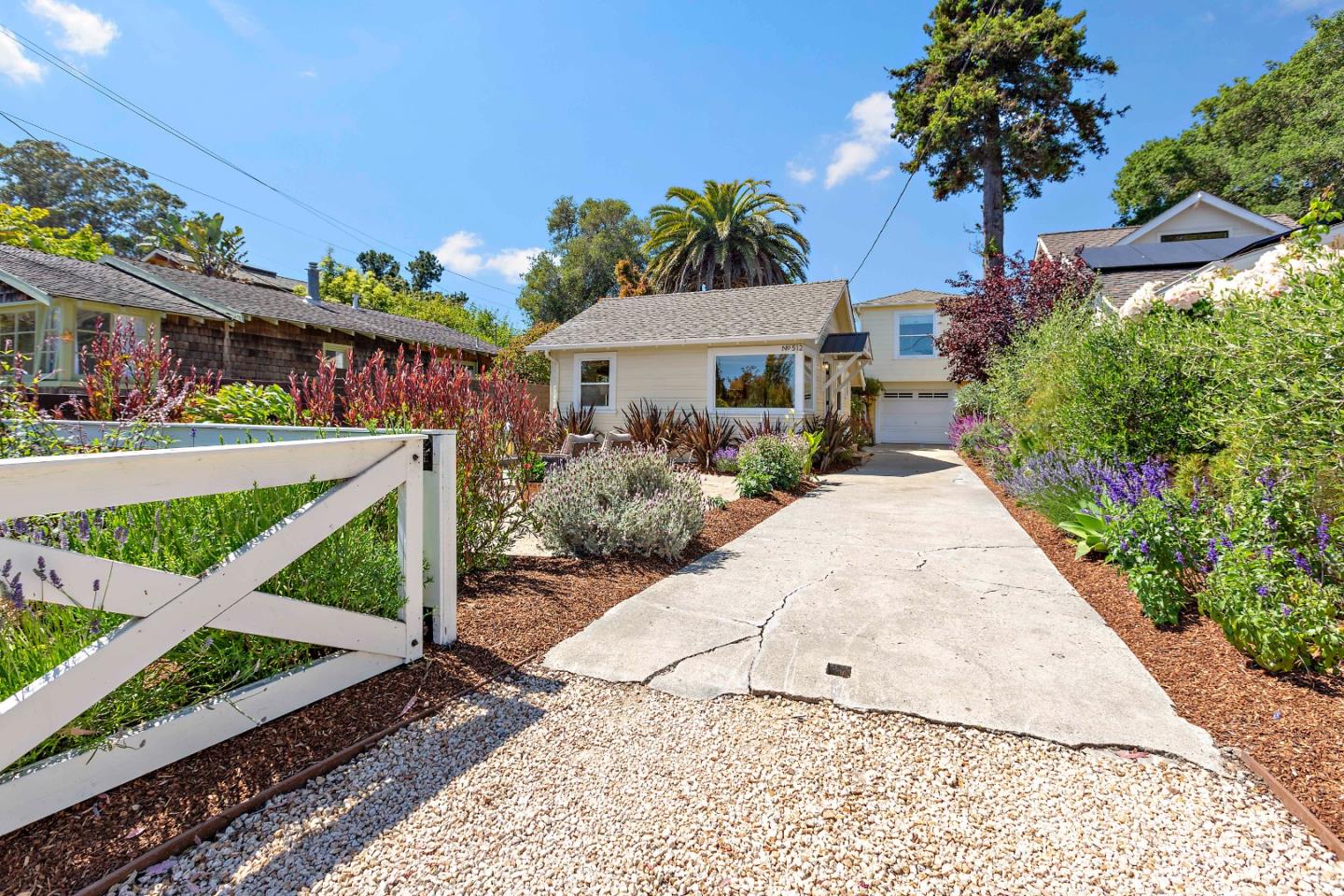 a front view of a house with a garden