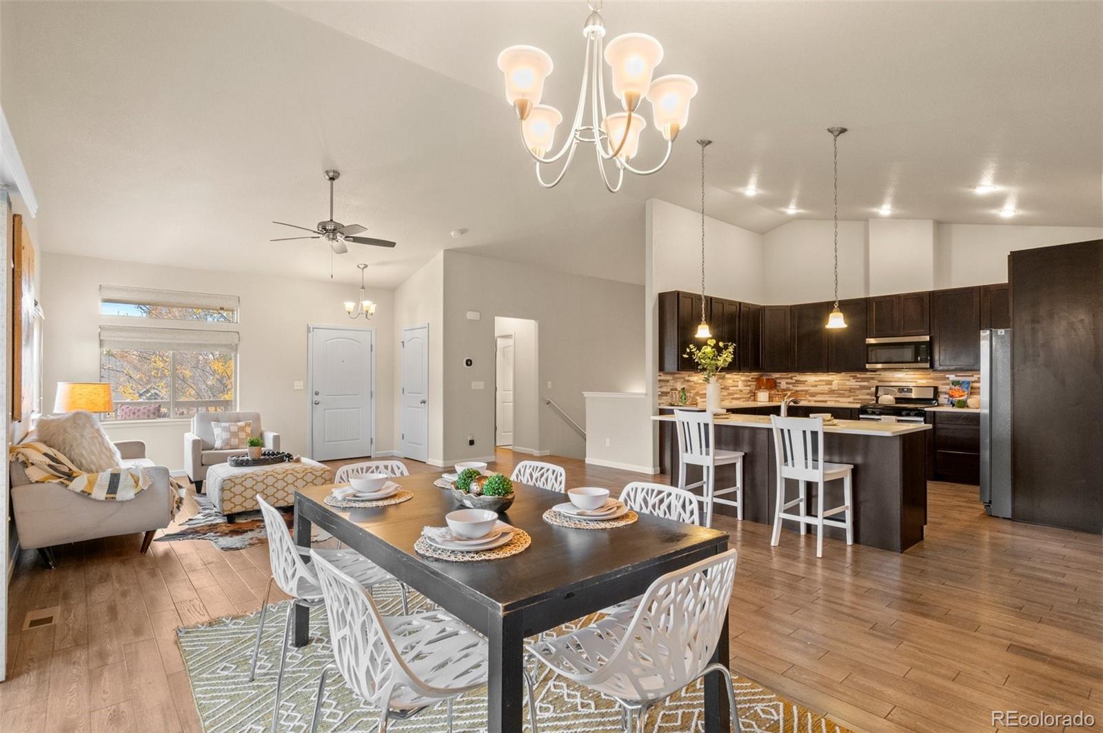 a large kitchen with a table and chairs