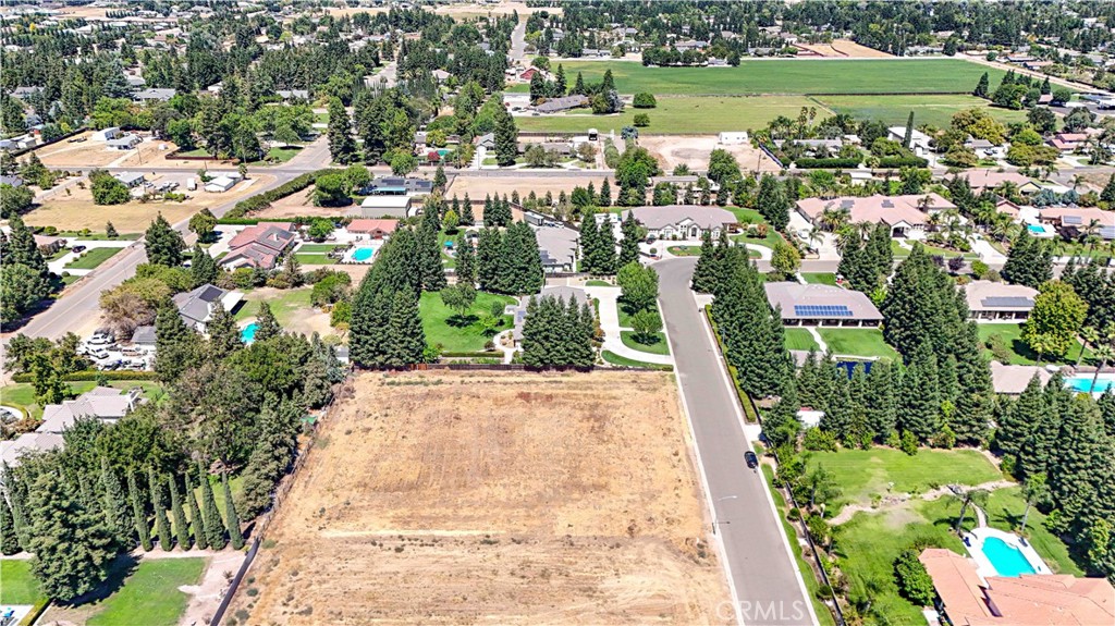 an aerial view of residential houses with outdoor space and street view