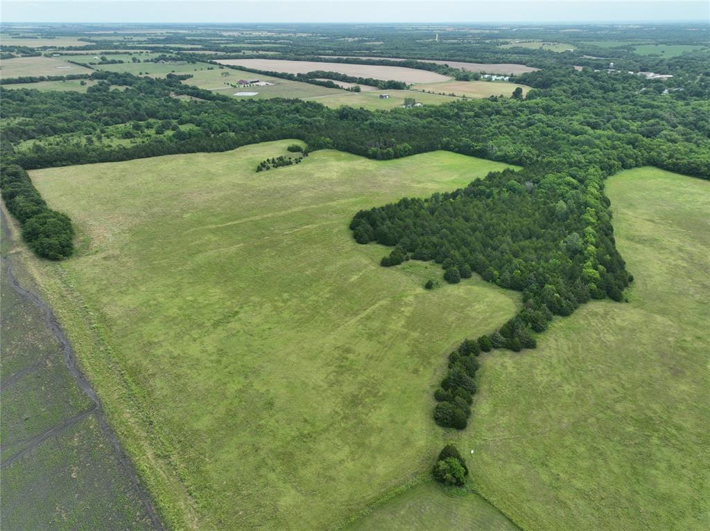 a view of a field with an ocean view