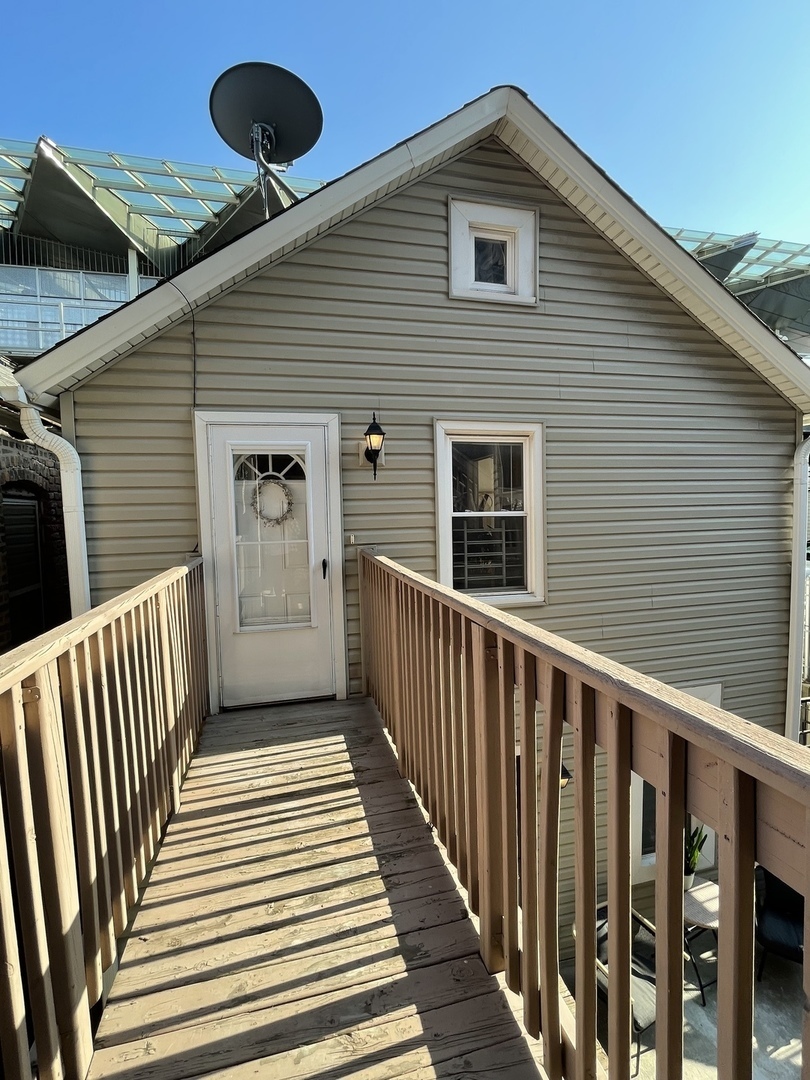 a view of a house with wooden deck