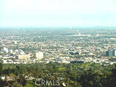 an aerial view of residential houses with city view