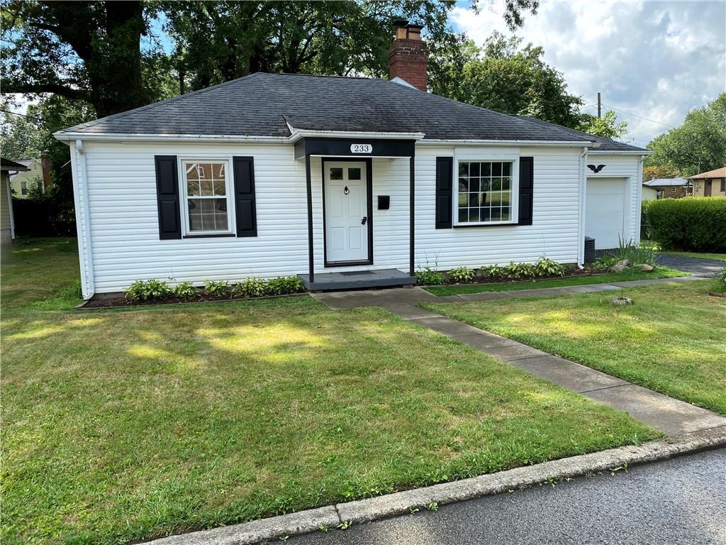 a house that has a big yard in front of it