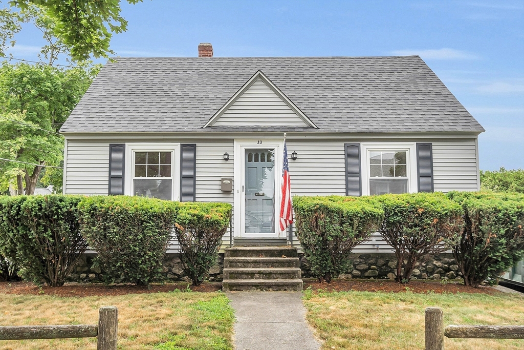 a front view of a house with potted plants