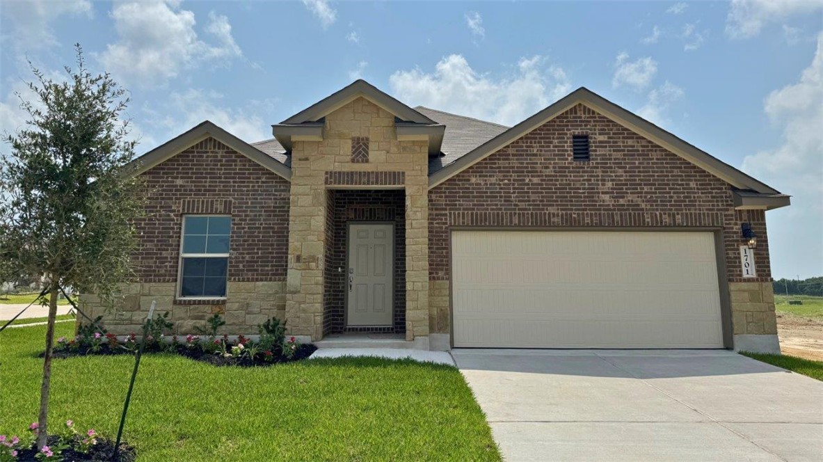 View of front of property featuring a garage and a