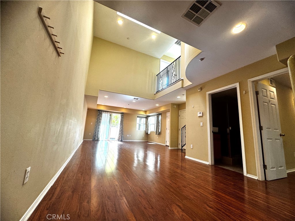 a view of hallway with wooden floor