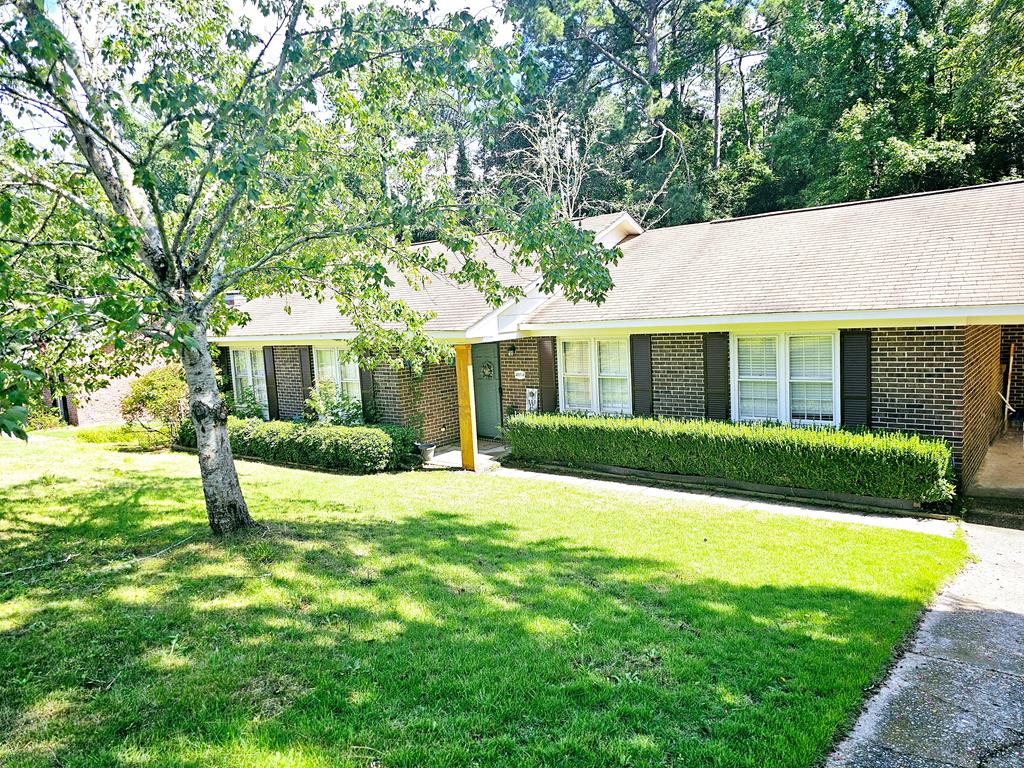 a house that has a big yard with large trees