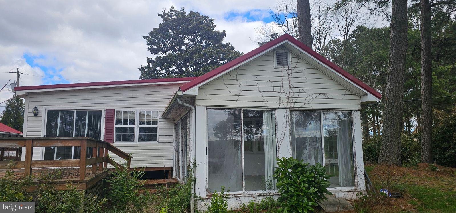 a view of a house with large windows and plants