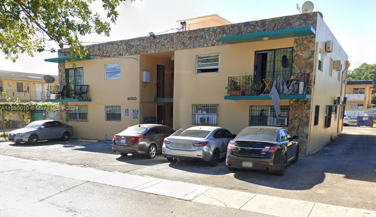 a view of cars parked in front of a house