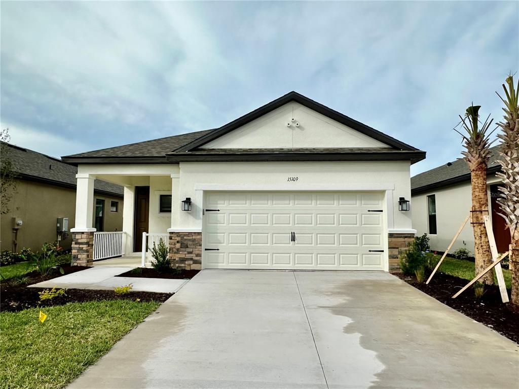 a front view of a house with a yard and garage