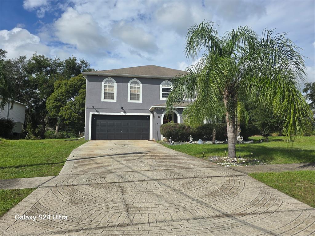 a front view of a house with a yard and garage